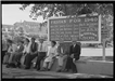 Several people resting in shade at Taos Fiestas 1940