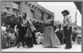 Two men and a woman dancing in the streets 1940