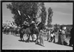 Two men riding horseback in a parade at Taos Fiestas 1940