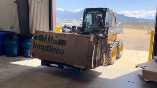 INTRO Daniel B. Young moving cardboard bales at the El Prado hub